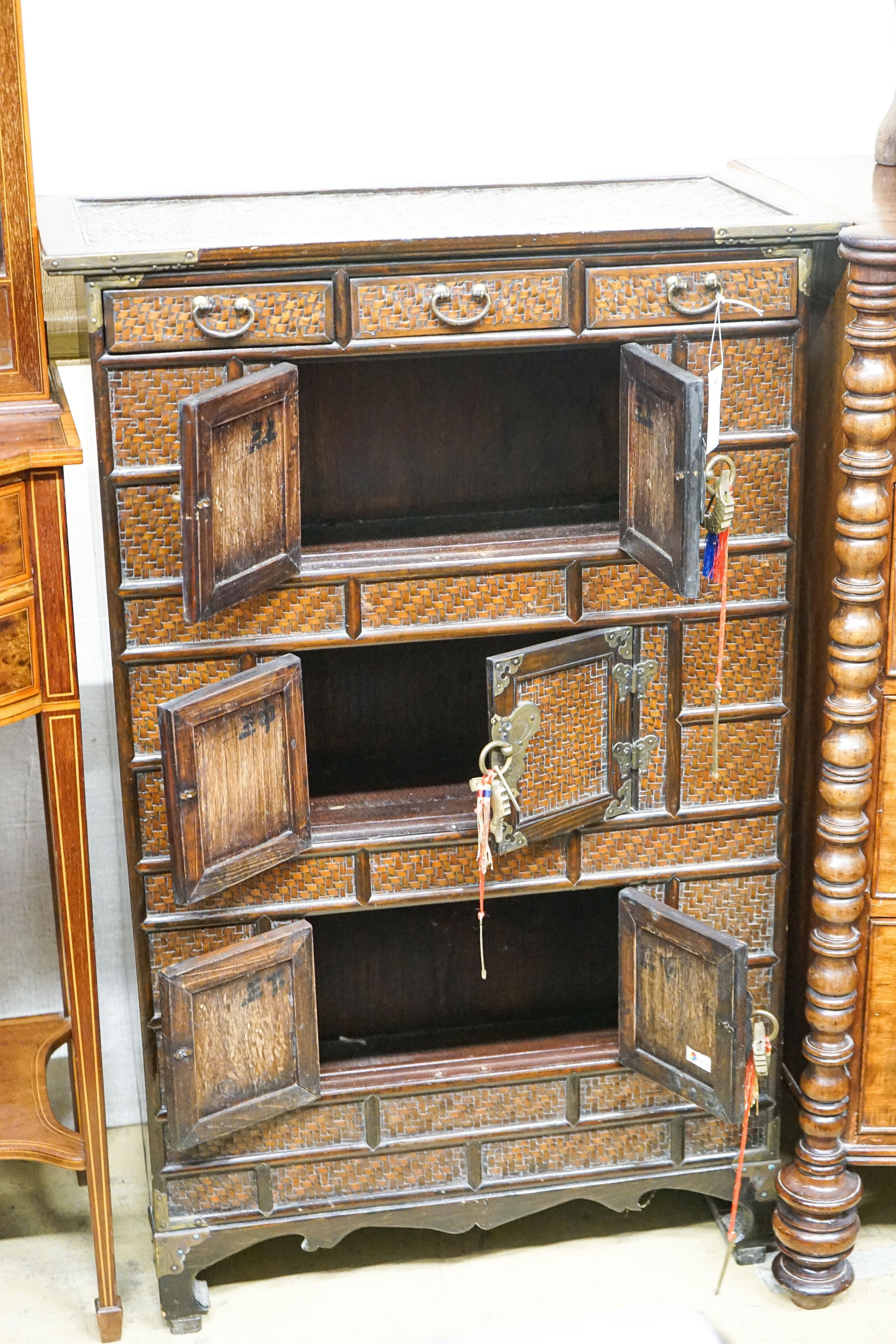 A 20th century Chinese stained wood and rattan side cabinet, width 67cm, depth 32cm, height 104cm